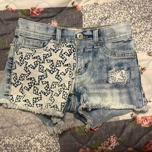 Acid wash blue Jean shorts with stars.